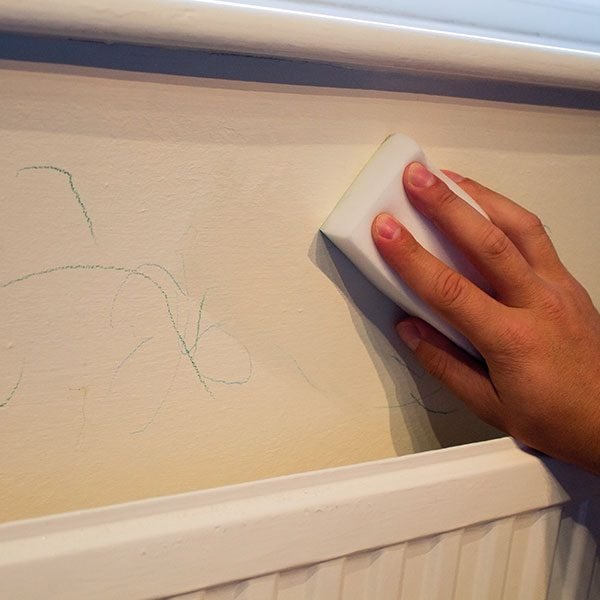 Removing Crayon from walls with our magic eraser.